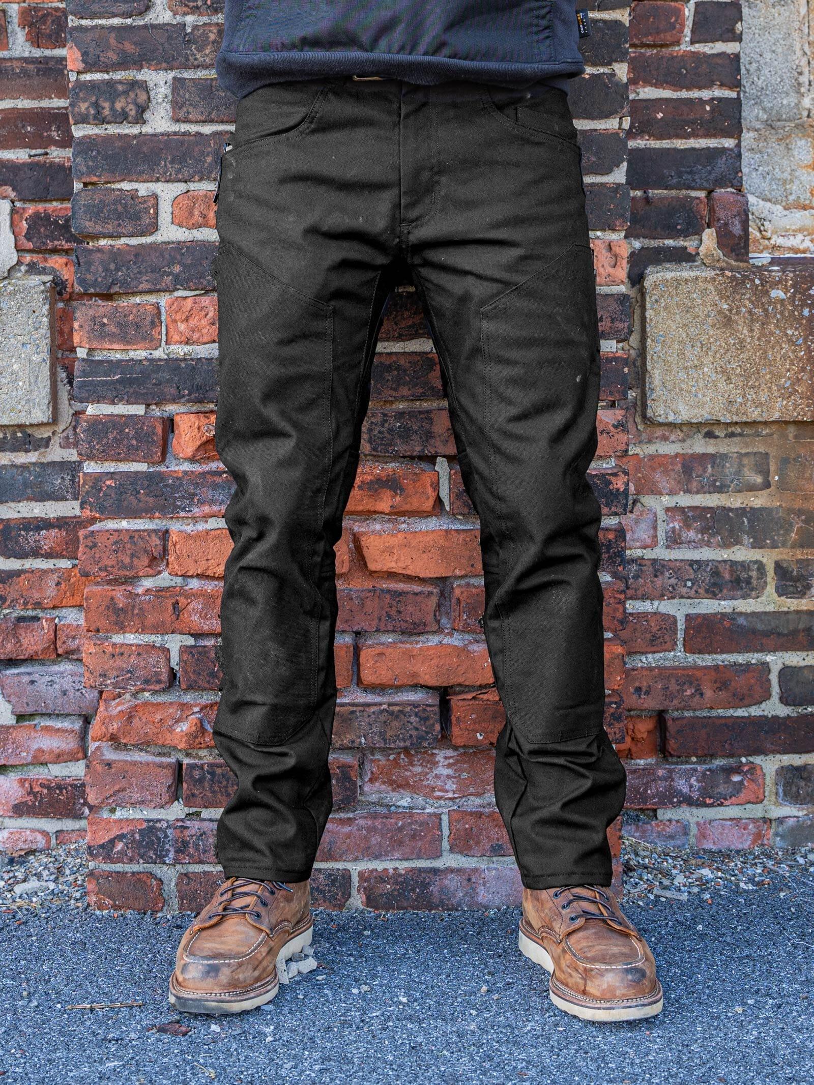 A tradesman wearing 1620 USA slim fit work pants in a workshop, highlighting a clean, tailored silhouette with reinforced utility pockets and high-mobility stretch fabric.